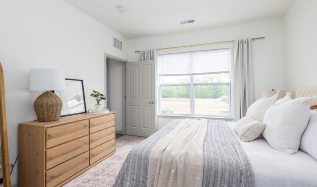 a bedroom with a bed and a dresser