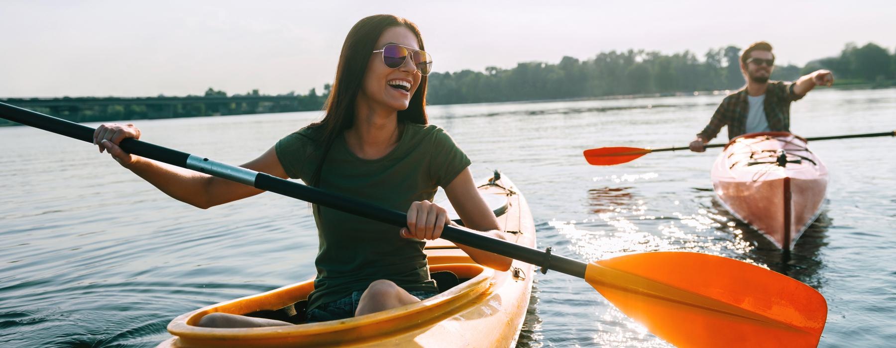 a smiling woman in a kayak